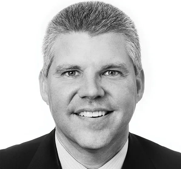 a black and white photo of a man in a suit and tie