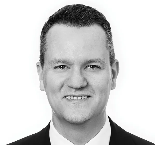 a black and white photo of a man in a suit