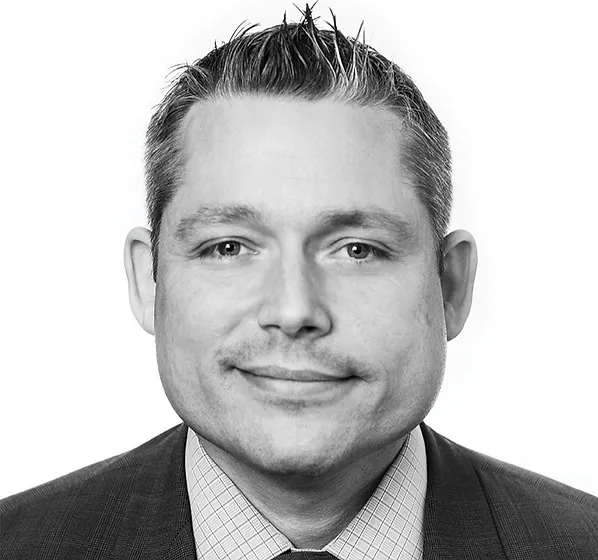 a black and white photo of a man in a suit