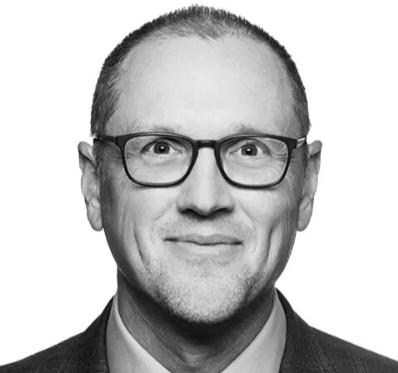 a black and white photo of a man wearing glasses