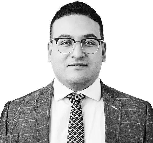 a black and white photo of a man wearing a suit and tie
