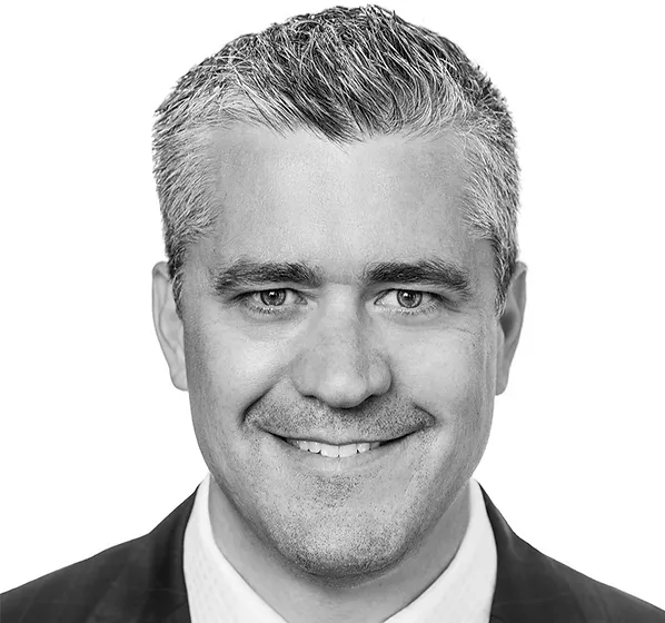a black and white photo of a man in a suit