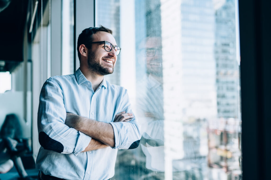 Man looks our the window having set his financial new years resolution